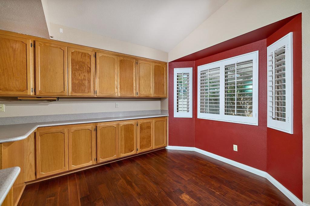 932 Alyssum Road Carlsbad, CA 92011 - Photo 10 of 31 a view of an empty room with wooden floor and a window