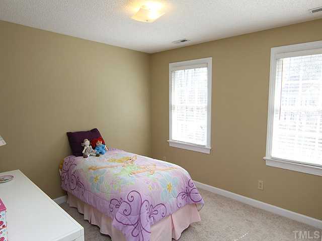 2402 Eddystone Road Raleigh, NC 27612 - Photo 19 of 25 a bedroom with a bed and a window