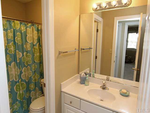 2402 Eddystone Road Raleigh, NC 27612 - Photo 21 of 25 a bathroom with a sink and a mirror
