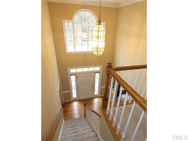 2402 Eddystone Road Raleigh, NC 27612 - Photo 4 of 25 a view of a livingroom with wooden floor and staircase