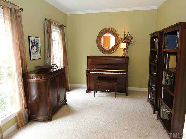 2402 Eddystone Road Raleigh, NC 27612 - Photo 5 of 25 a living room with furniture and a fireplace