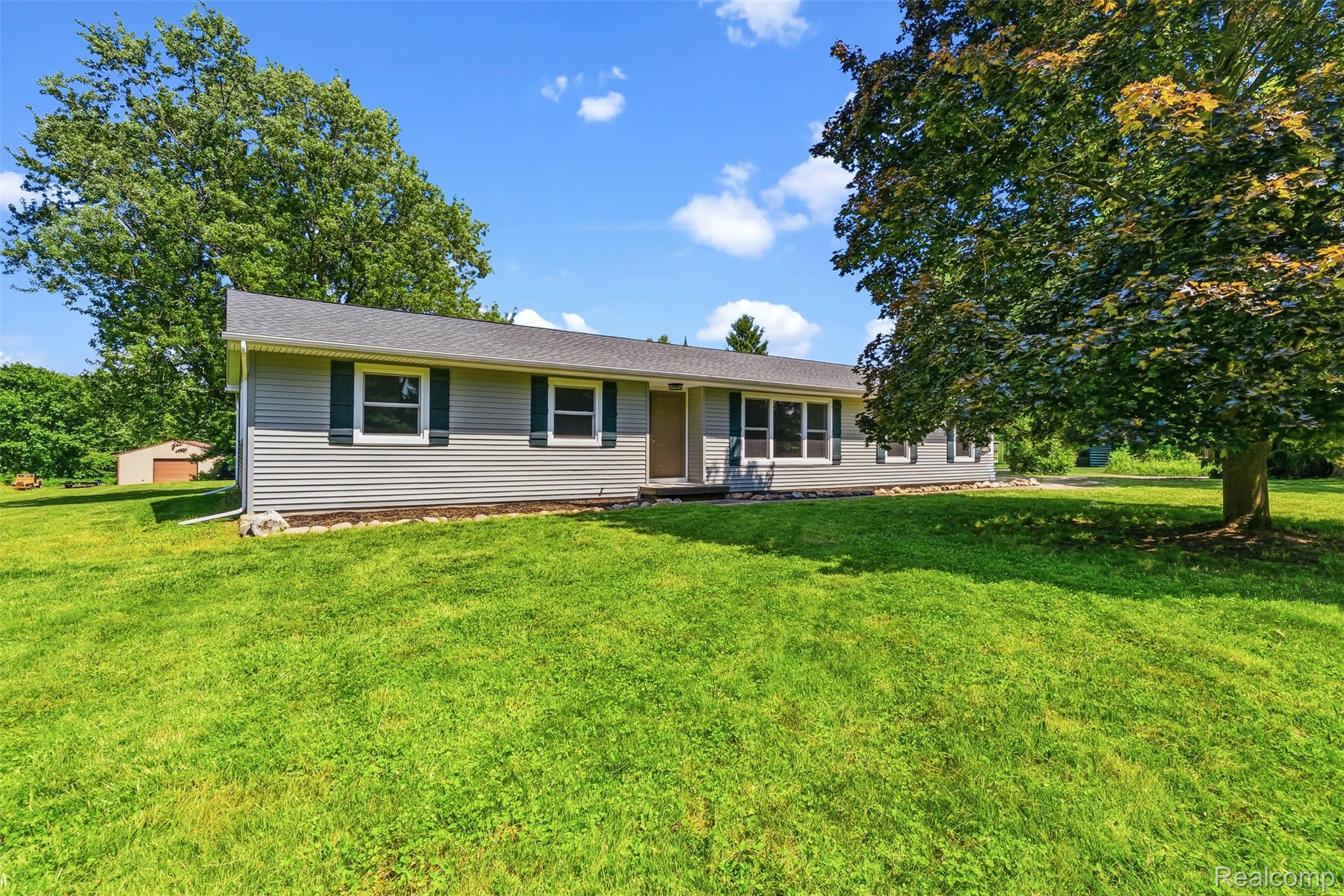 9200 Hickory Ridge Road Holly, MI 48442 - Photo 2 of 33 Single-story residence featuring gray horizontal siding and a dark gray roof