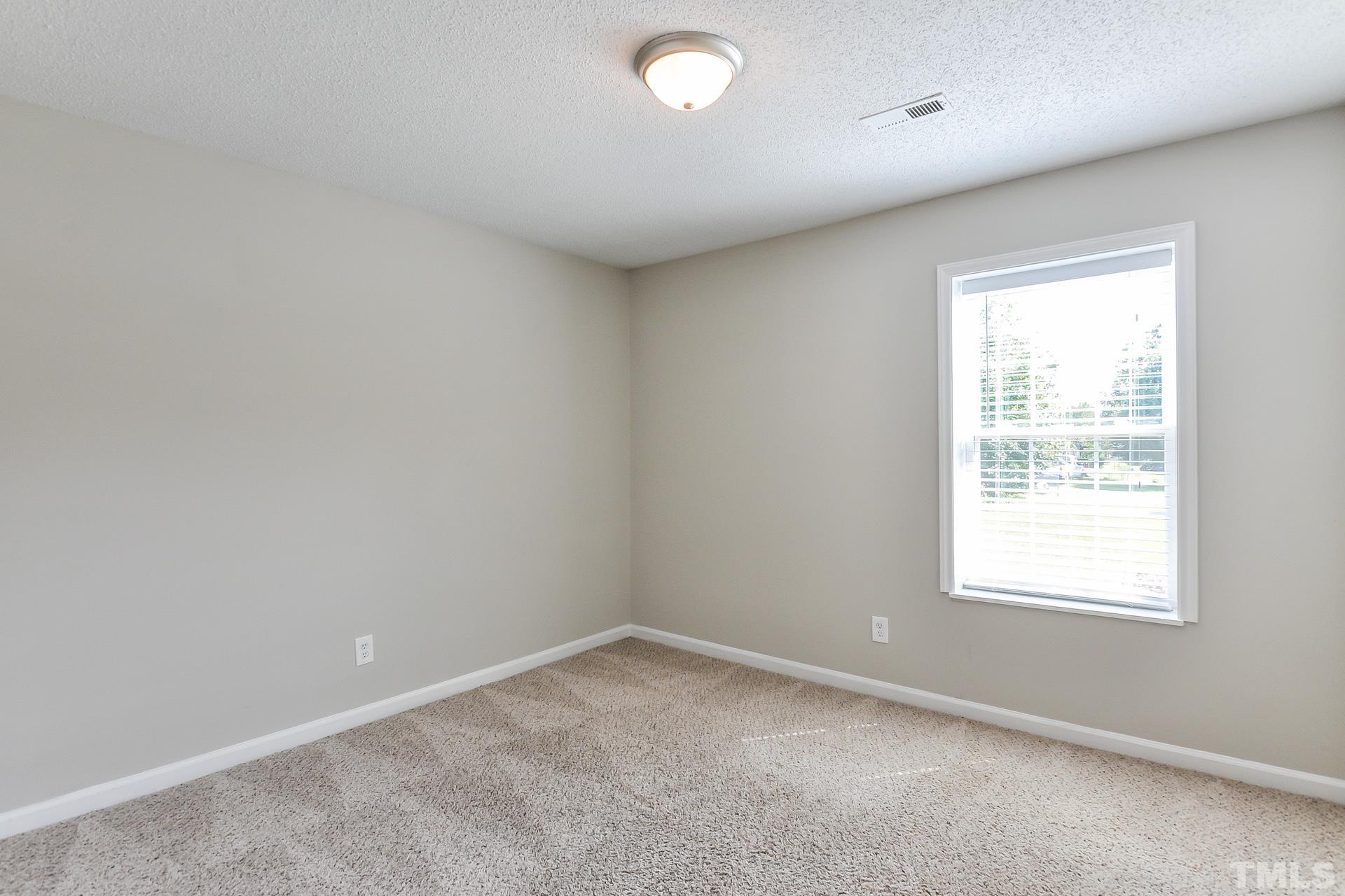 38 Greene Court Angier, NC 27501 - Photo 12 of 16 an empty room with a window