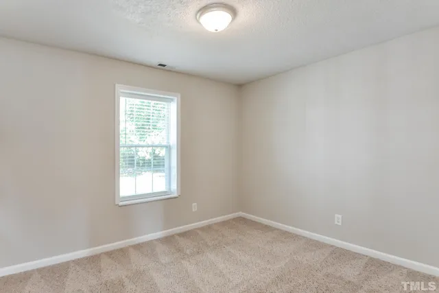 a bathroom with a sink vanity mirror and toilet