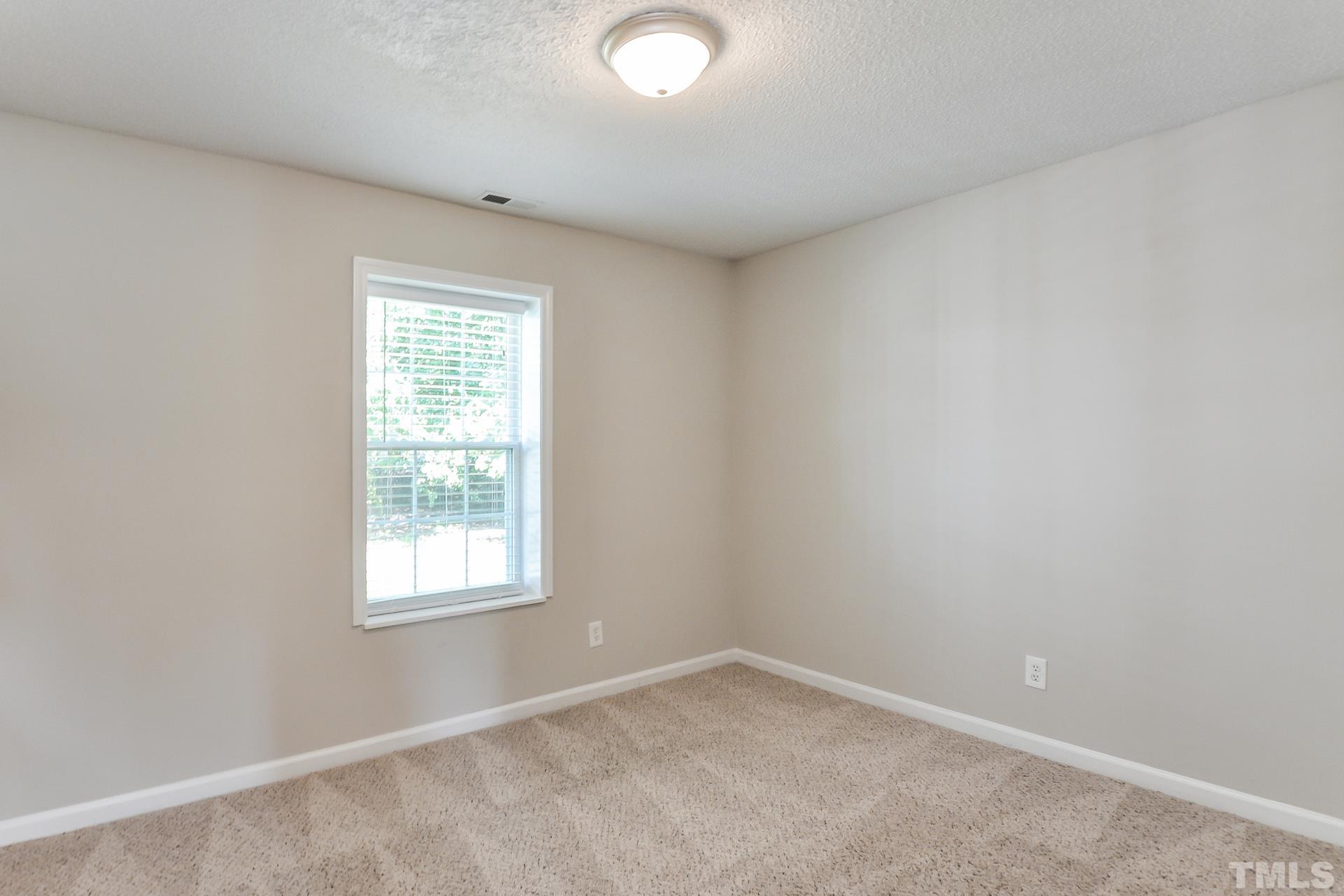 38 Greene Court Angier, NC 27501 - Photo 13 of 16 an empty room with a window