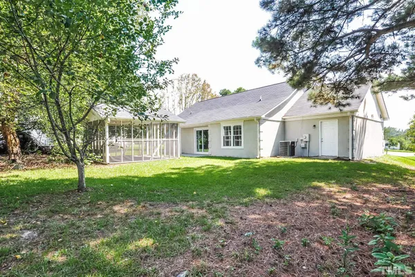 a view of a house with a yard and sitting area