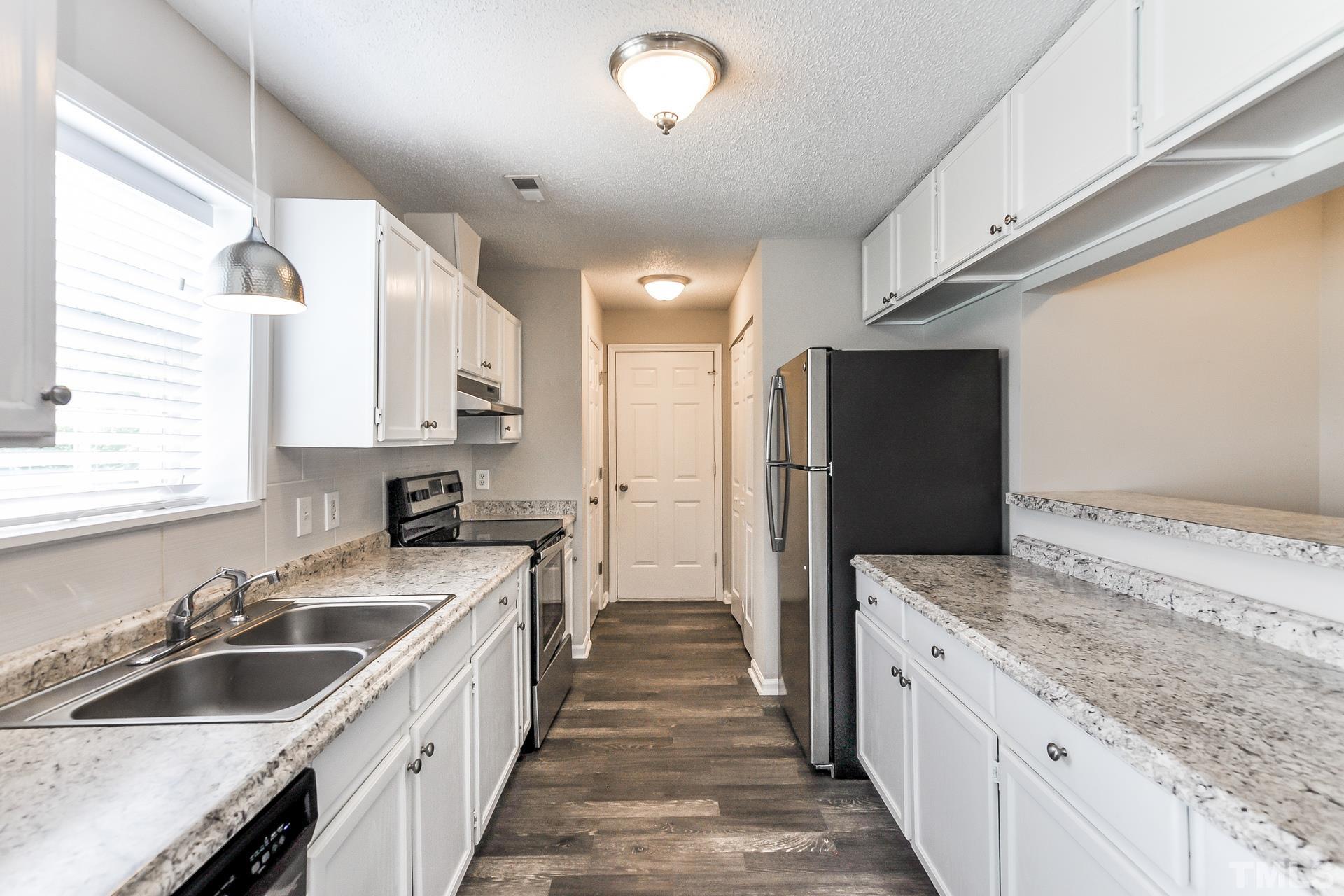 38 Greene Court Angier, NC 27501 - Photo 6 of 16 a kitchen with a sink stove and refrigerator
