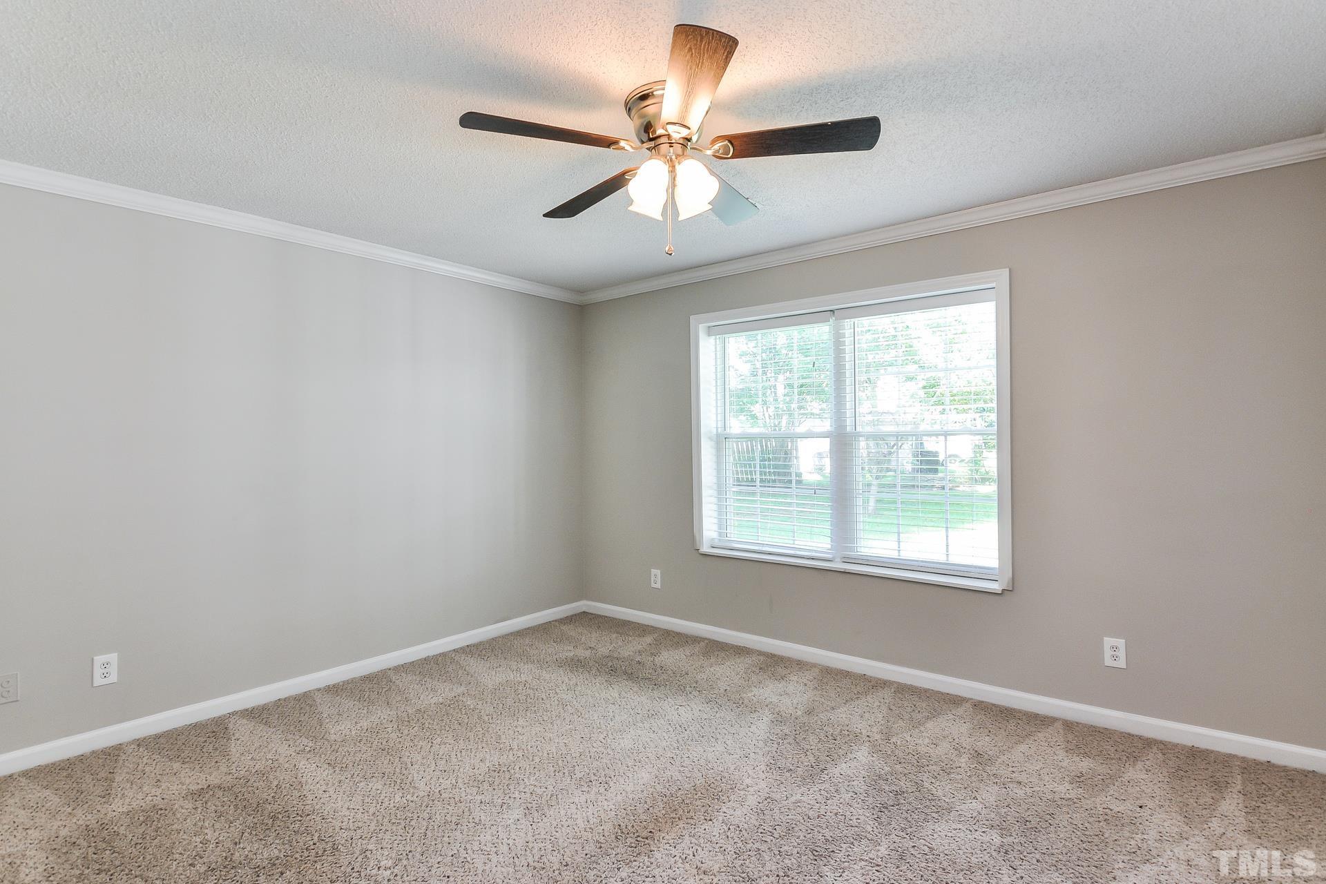 38 Greene Court Angier, NC 27501 - Photo 10 of 16 an empty room with a window and a fan