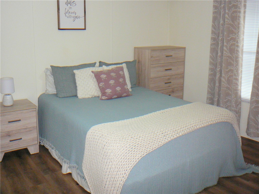 34 Owens Point Road Abbeville, SC 29620 - Photo 15 of 22 This cozy bedroom features durable flooring and window blinds, creating a comfortable and private retreat.