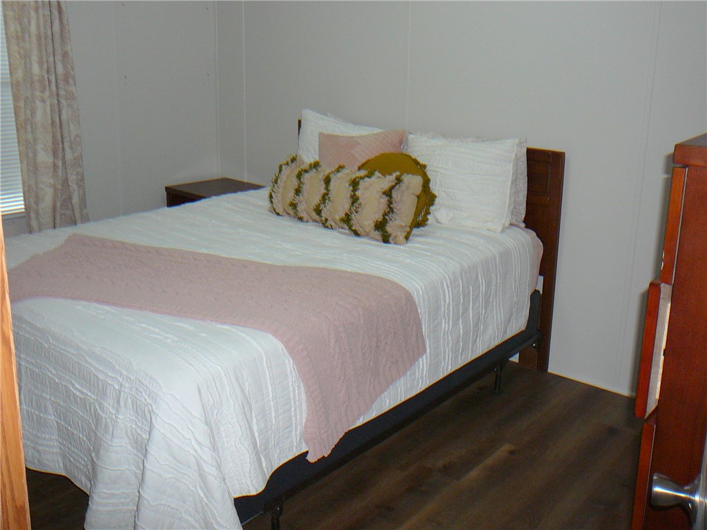 34 Owens Point Road Abbeville, SC 29620 - Photo 17 of 22 This cozy bedroom features durable flooring and ample natural light, creating a comfortable living space.