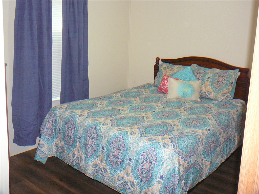 34 Owens Point Road Abbeville, SC 29620 - Photo 18 of 22 This cozy bedroom features durable flooring and ample natural light, creating a comfortable and inviting atmosphere.