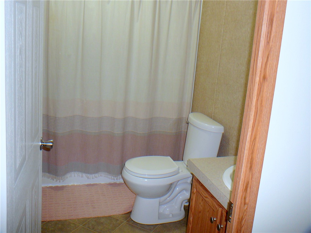 34 Owens Point Road Abbeville, SC 29620 - Photo 19 of 22 This functional bathroom features practical fixtures and a neutral palette, creating a versatile space.