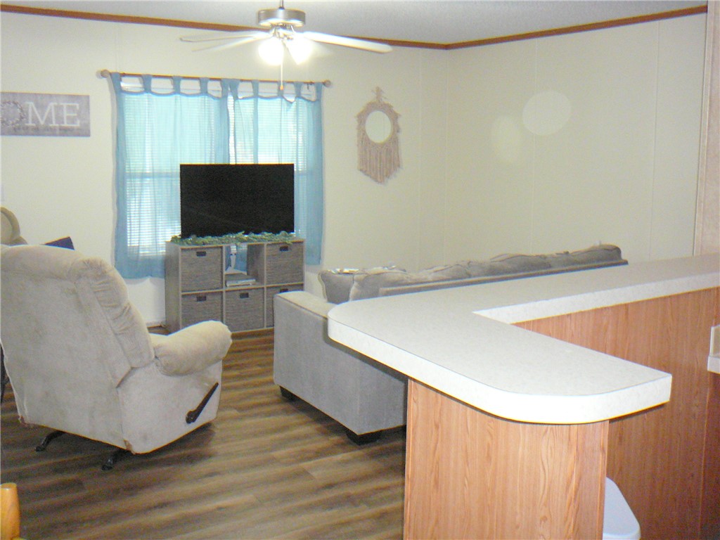 34 Owens Point Road Abbeville, SC 29620 - Photo 20 of 22 This inviting living space features warm flooring and convenient counter seating.