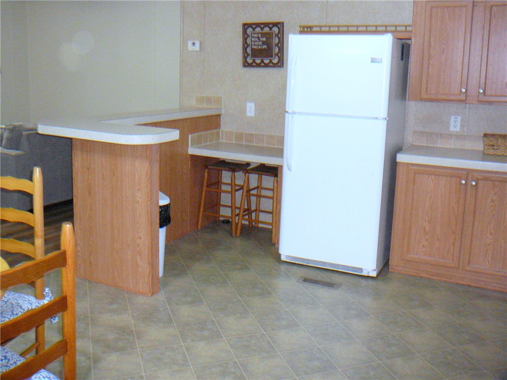 34 Owens Point Road Abbeville, SC 29620 - Photo 21 of 22 This functional kitchen features a breakfast bar, ample cabinetry, and durable flooring for everyday living.