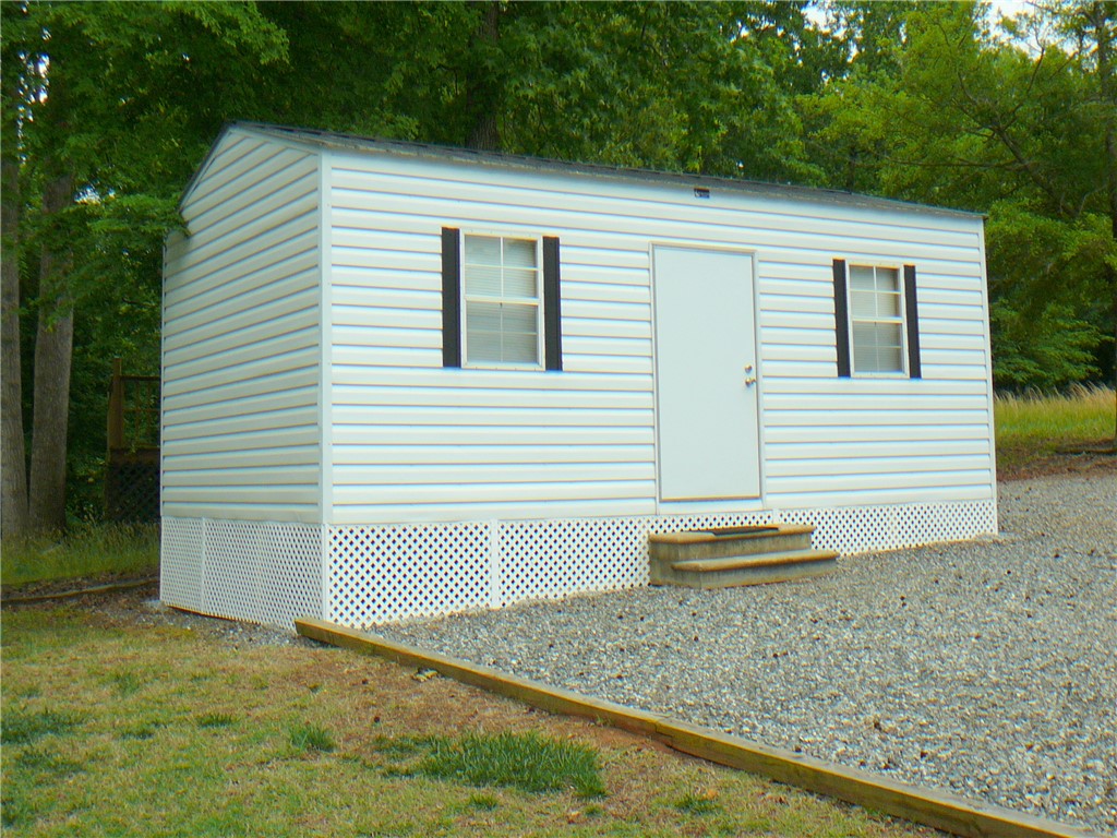 34 Owens Point Road Abbeville, SC 29620 - Photo 22 of 22 This outdoor shed offers practical storage and functionality, featuring durable siding and a clean design.