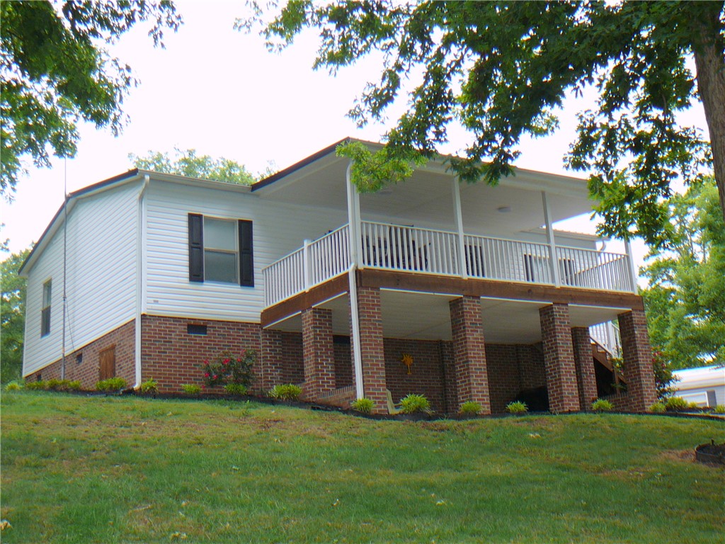 34 Owens Point Road Abbeville, SC 29620 - Photo 3 of 22 This elevated residence features a welcoming porch, perfect for outdoor enjoyment.