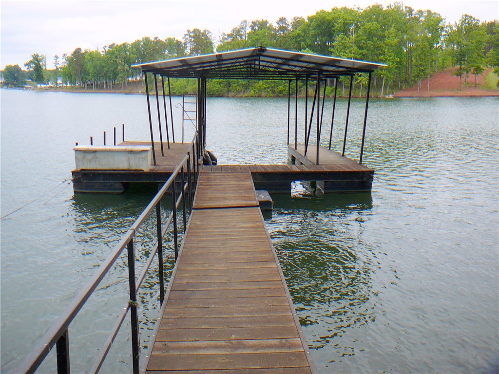 34 Owens Point Road Abbeville, SC 29620 - Photo 4 of 22 This tranquil waterfront setting includes a private boat dock with a covered slip, perfect for aquatic adventures.
