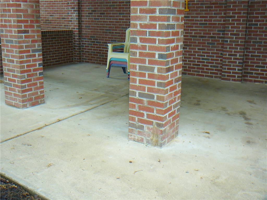 34 Owens Point Road Abbeville, SC 29620 - Photo 9 of 22 This inviting patio area features durable brick columns and walls, perfect for outdoor relaxation.