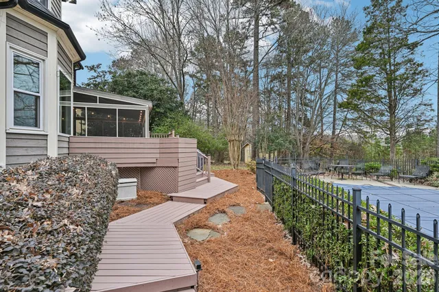 a view of house with backyard and sitting area