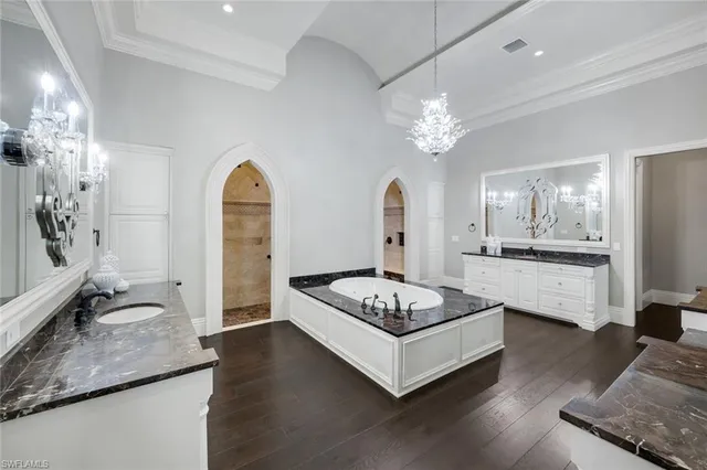a bathroom with a granite countertop sink mirror and toilet