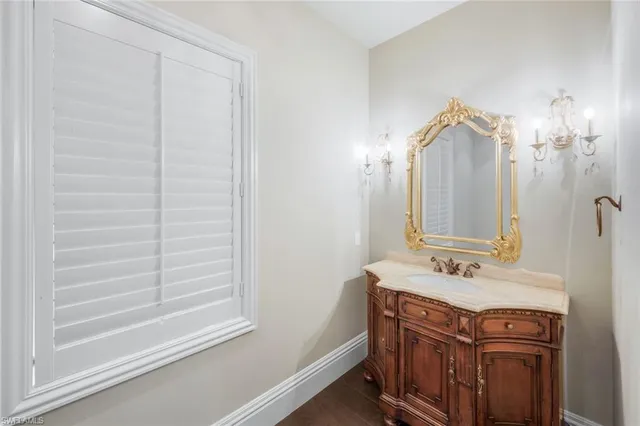 a bedroom with a bed a chandelier and a window