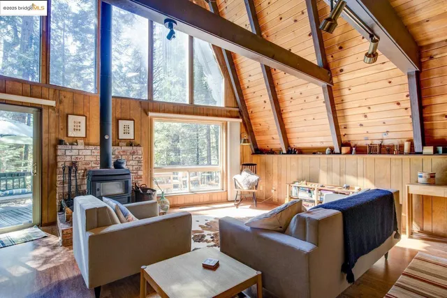 a living room with furniture and large windows