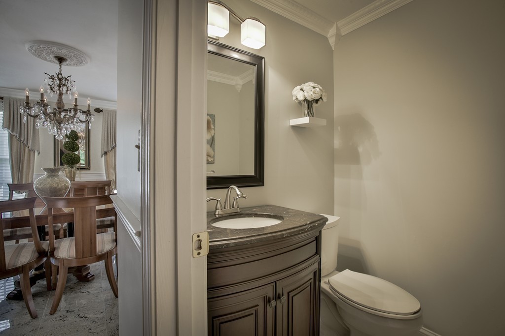 10 Hammersmith Drive Saugus, MA 01906 - Photo 14 of 30 a bathroom with a granite countertop toilet a sink and a mirror