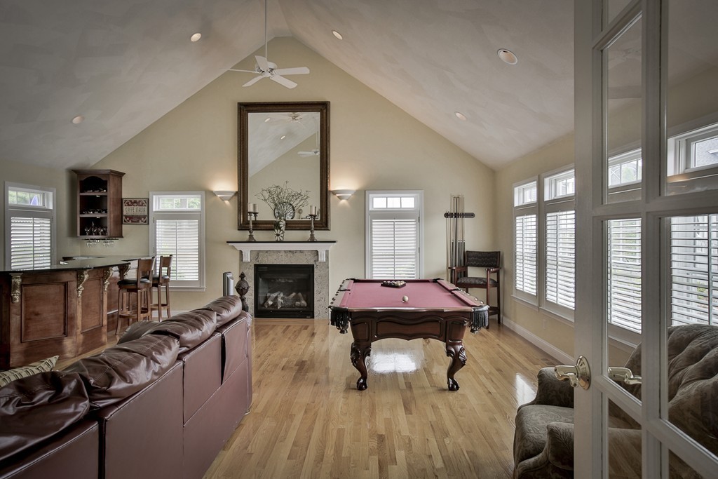 10 Hammersmith Drive Saugus, MA 01906 - Photo 15 of 30 a living room with furniture a fireplace and large windows