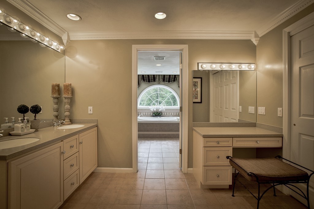 10 Hammersmith Drive Saugus, MA 01906 - Photo 24 of 30 a bathroom with a granite countertop sink a toilet and a mirror