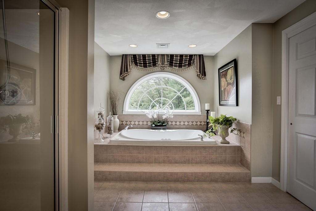 10 Hammersmith Drive Saugus, MA 01906 - Photo 25 of 30 a bathroom with a bathtub and a chandelier