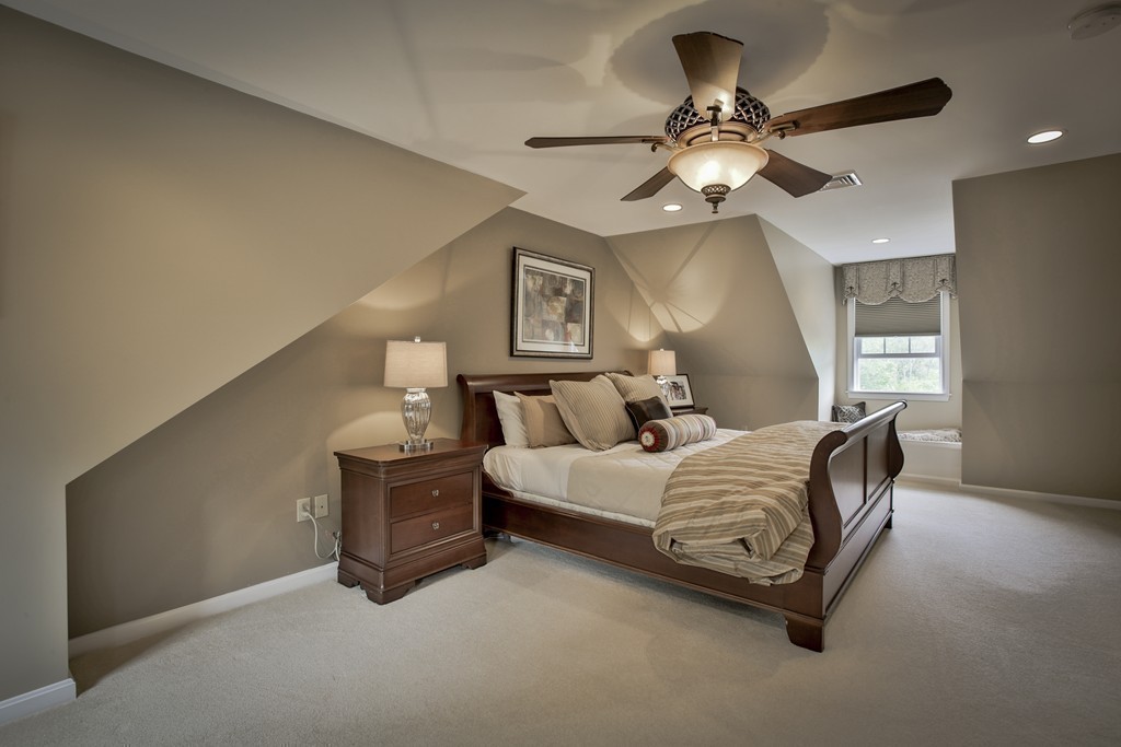 10 Hammersmith Drive Saugus, MA 01906 - Photo 26 of 30 a room with a bed and a chandelier