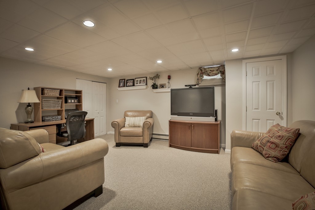 10 Hammersmith Drive Saugus, MA 01906 - Photo 29 of 30 a living room with furniture and a flat screen tv