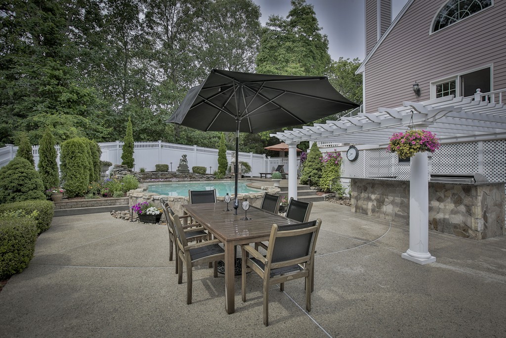10 Hammersmith Drive Saugus, MA 01906 - Photo 5 of 30 a view of a patio with a table and chairs under an umbrella