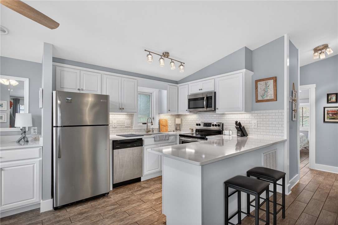 1230 Melton Road, Unit 4 West Union, SC 29696 - Photo 40 of 48 A well-appointed kitchen features stainless steel appliances, gleaming countertops, and a subway tile backsplash.