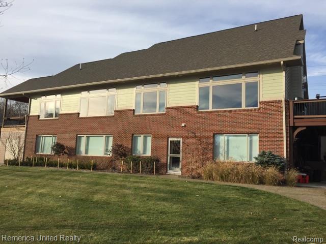 3467 East Commerce Road Commerce Township, MI 48382 - Photo 2 of 36 Rear view of home. Professional Landscaping including exterior lights on photocell. Storage under upper deck for your water toys! Patio under second upper deck provides shaded entertainment area.