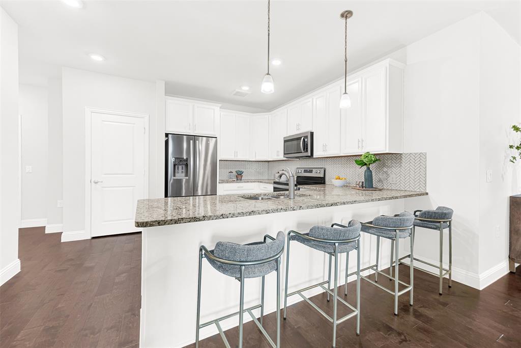 651 Watters Road, Unit 7406 Allen, TX 75013 - Photo 18 of 36 Beautiful granite countertops with spacious bar seating