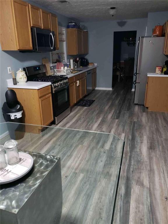 7808 Providence Point Way Lithonia, GA 30058 - Photo 11 of 23 a kitchen with stainless steel appliances granite countertop a sink a stove and a wooden floors