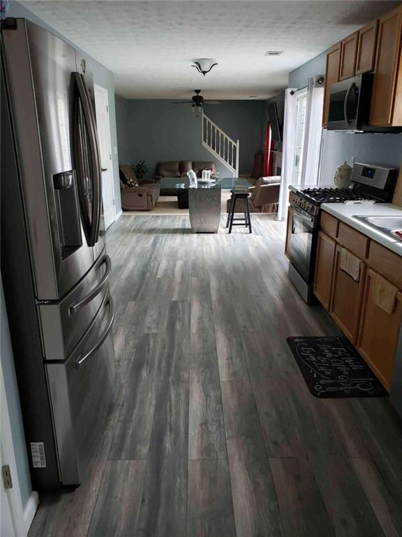 7808 Providence Point Way Lithonia, GA 30058 - Photo 13 of 23 a kitchen with stainless steel appliances a refrigerator a stove a sink dishwasher a oven with wooden floor and cabinets