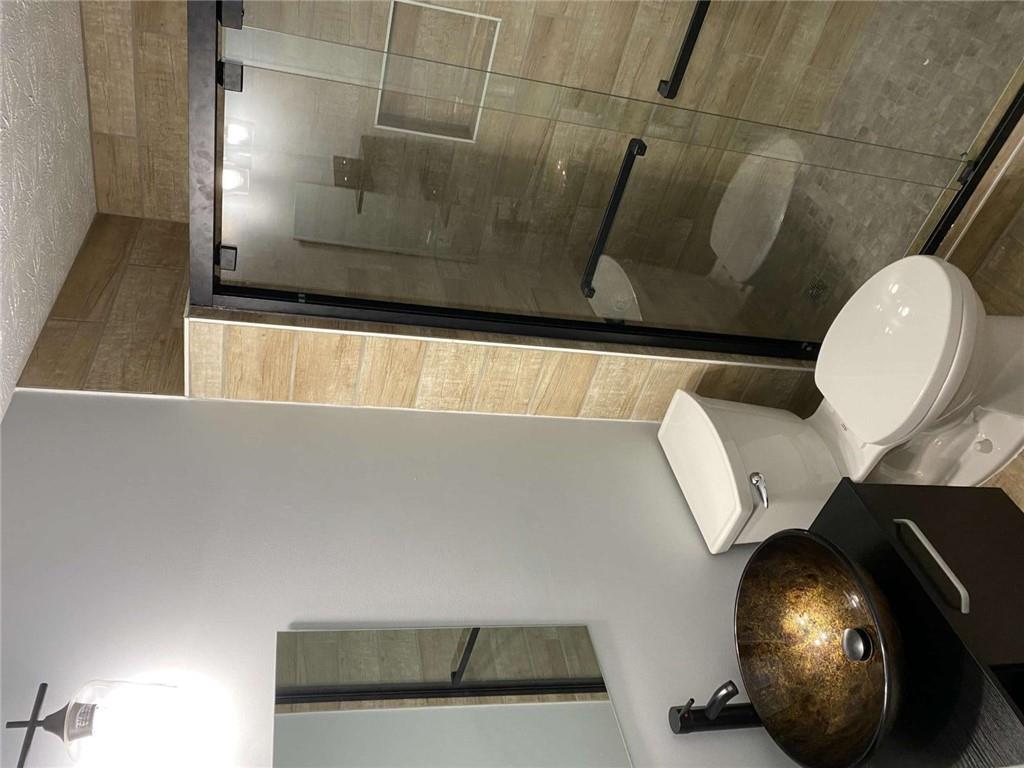 7808 Providence Point Way Lithonia, GA 30058 - Photo 15 of 23 a bathroom with a toilet and a shower