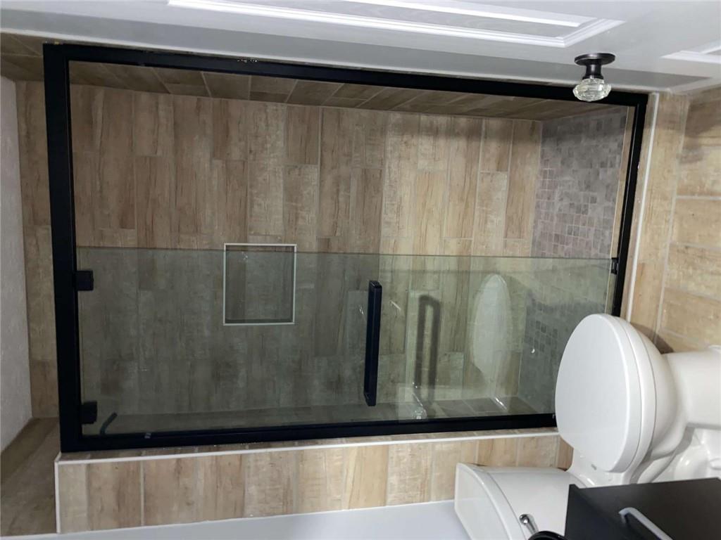 7808 Providence Point Way Lithonia, GA 30058 - Photo 17 of 23 a bathroom with a shower and a toilet