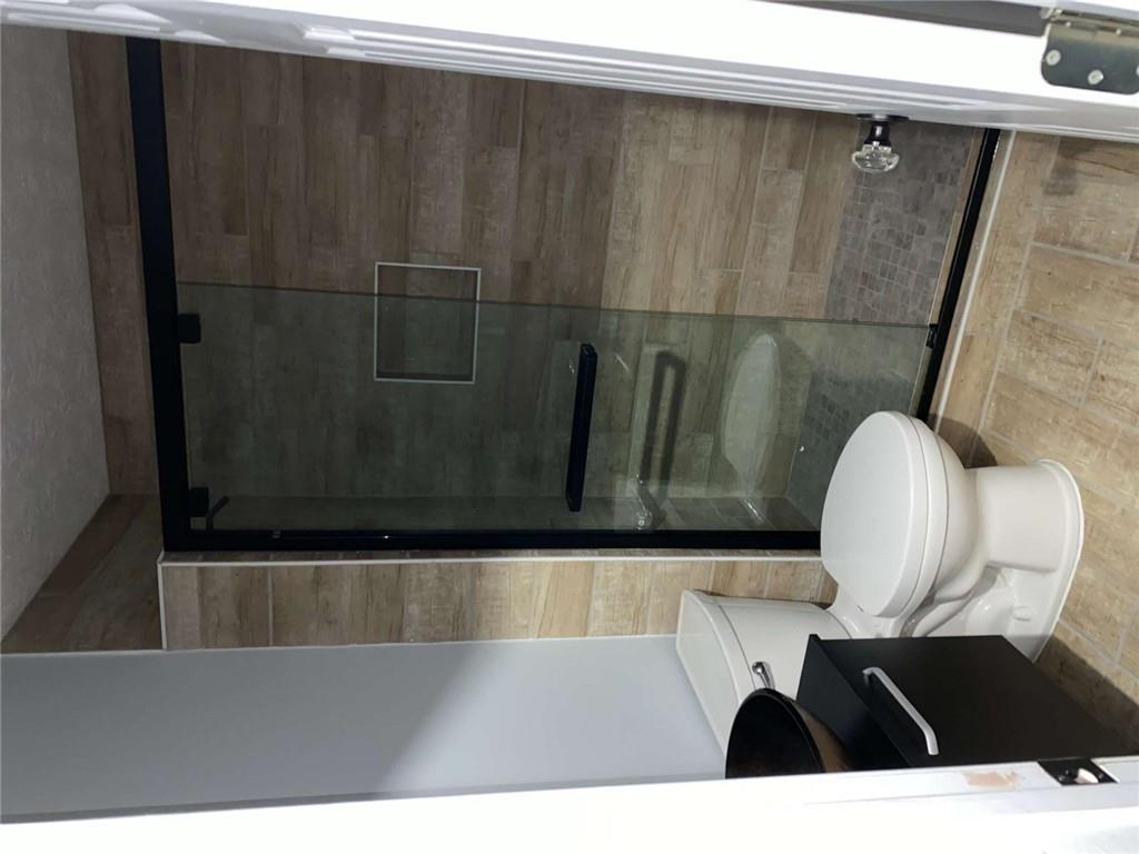 7808 Providence Point Way Lithonia, GA 30058 - Photo 18 of 23 a bathroom with a toilet and a shower