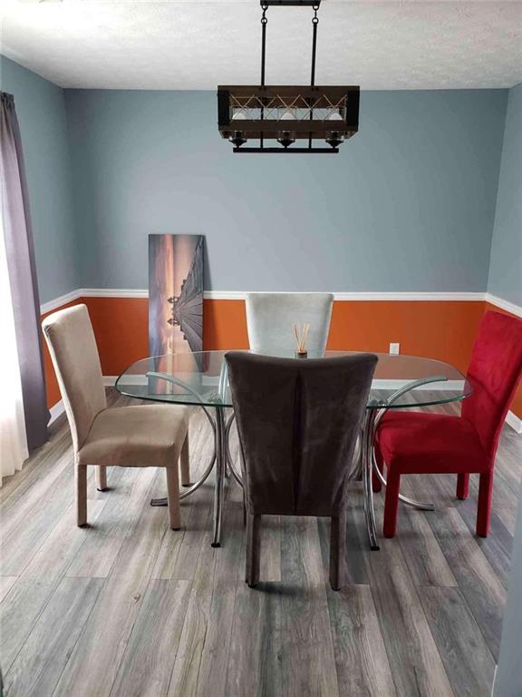 7808 Providence Point Way Lithonia, GA 30058 - Photo 7 of 23 a blue table sitting next to a white chair and a wooden floor