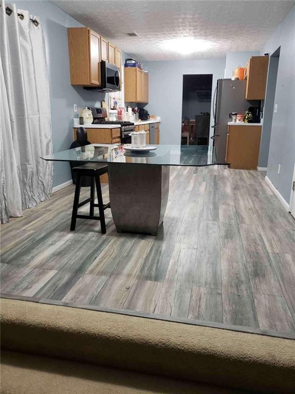 7808 Providence Point Way Lithonia, GA 30058 - Photo 10 of 23 a living room with stainless steel appliances kitchen island granite countertop furniture a large window
