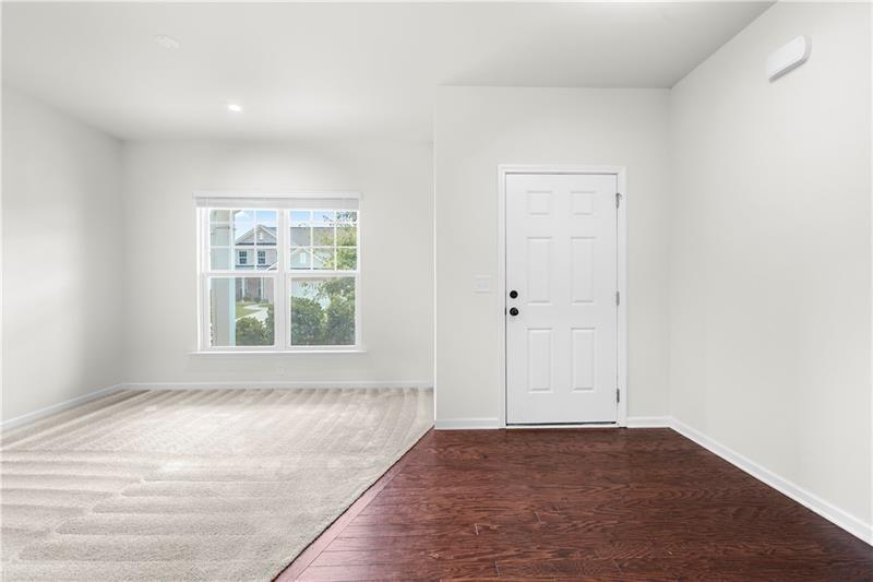 5899 Wheeler Ridge Road Auburn, GA 30011 - Photo 13 of 43 an empty room with wooden floor and windows