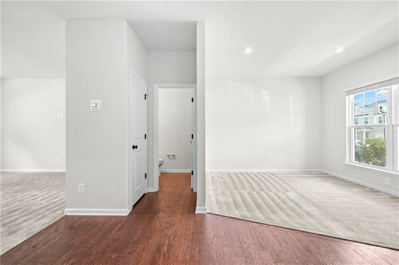 5899 Wheeler Ridge Road Auburn, GA 30011 - Photo 15 of 43 wooden floor in an empty room with a window