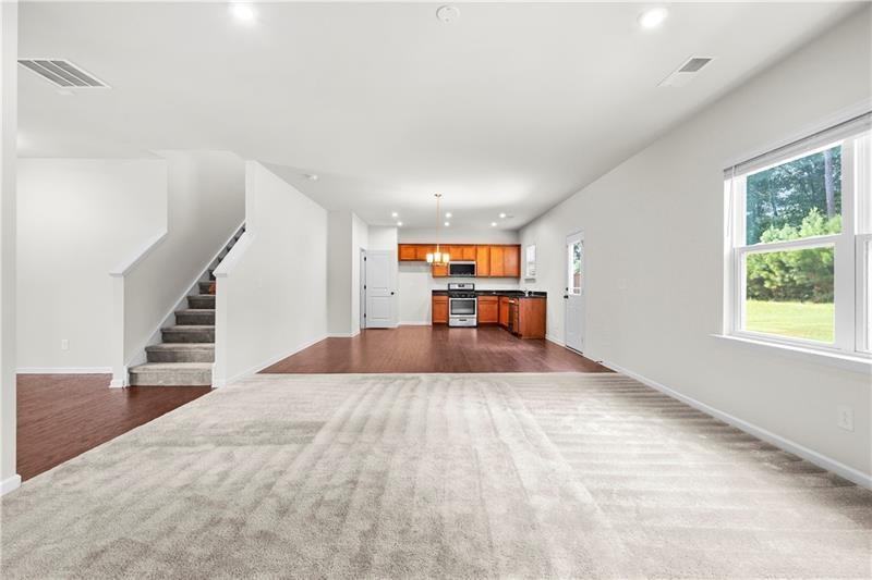 5899 Wheeler Ridge Road Auburn, GA 30011 - Photo 18 of 43 a view of empty room with wooden floor and window