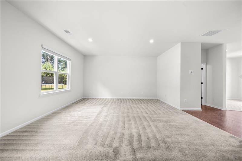5899 Wheeler Ridge Road Auburn, GA 30011 - Photo 20 of 43 a view of an empty room with a window and wooden floor