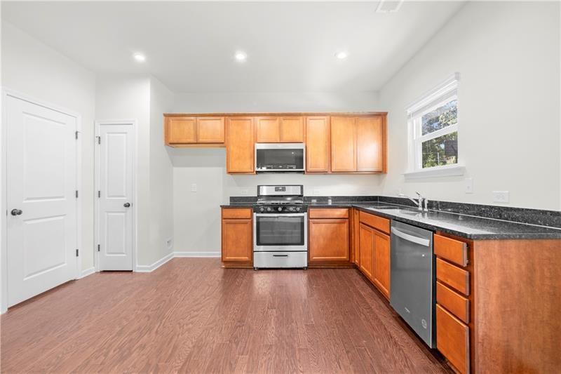 5899 Wheeler Ridge Road Auburn, GA 30011 - Photo 23 of 43 a kitchen with stainless steel appliances granite countertop a stove a sink and a refrigerator