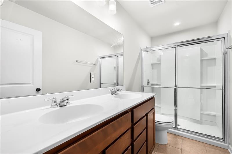 5899 Wheeler Ridge Road Auburn, GA 30011 - Photo 36 of 43 a bathroom with a sink double vanity and a shower