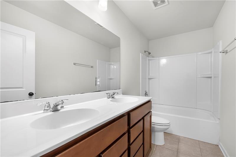 5899 Wheeler Ridge Road Auburn, GA 30011 - Photo 43 of 43 a bathroom with a sink a toilet and shower